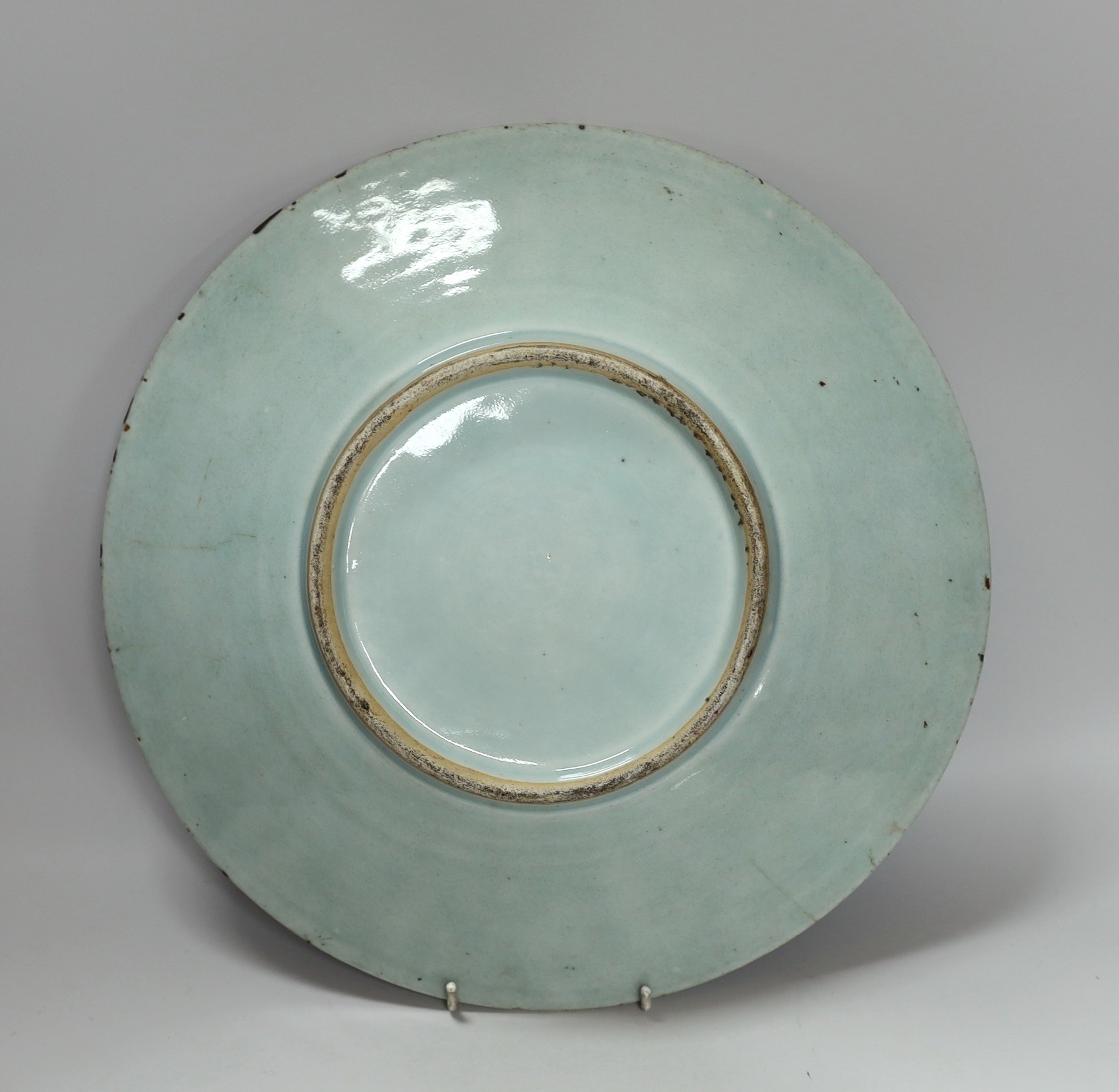 A 19th century Chinese famille rose enamelled carved celadon glazed dish, 34cm